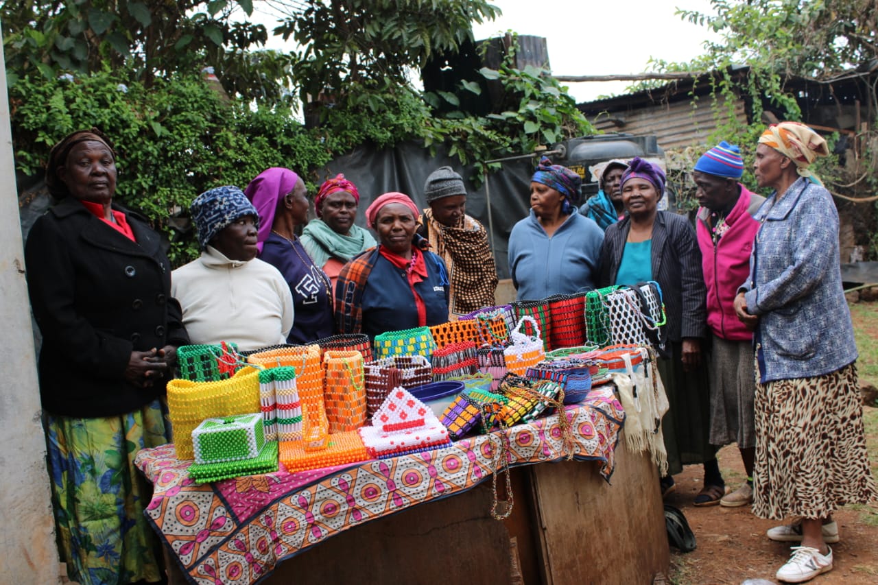 Women with handmade beadwork from a livelihood gathering