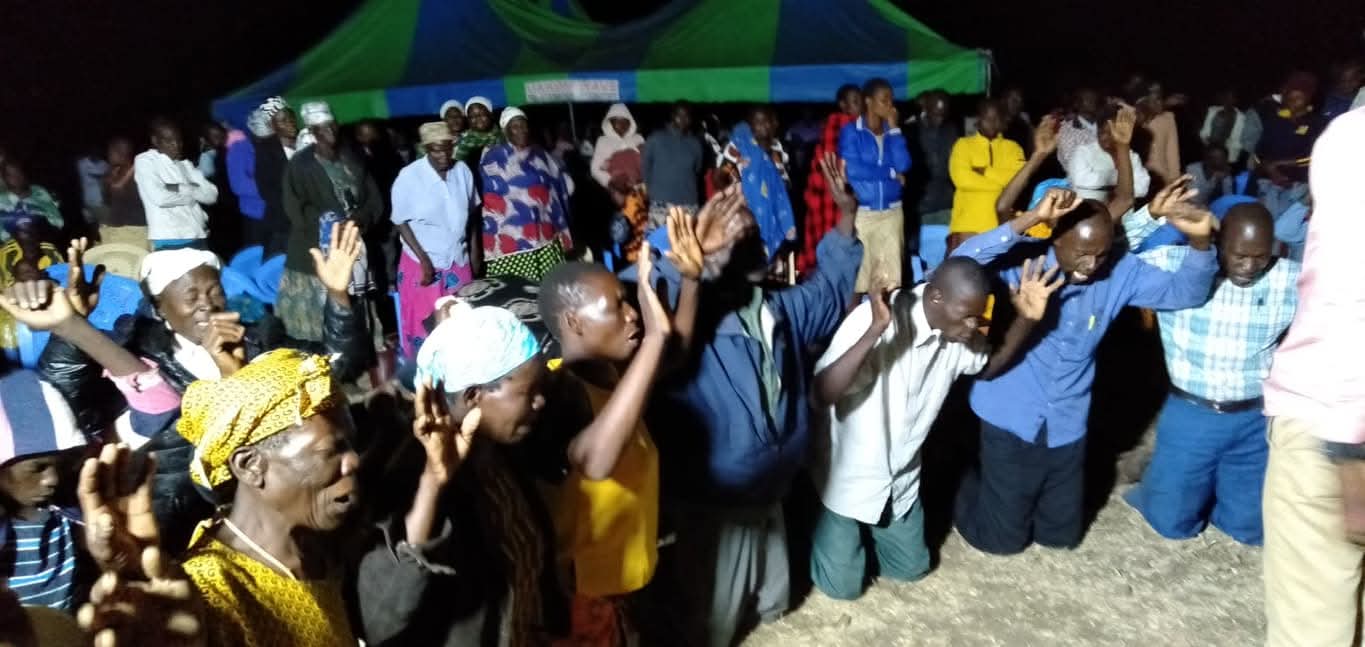 An evening community outreach under a tent